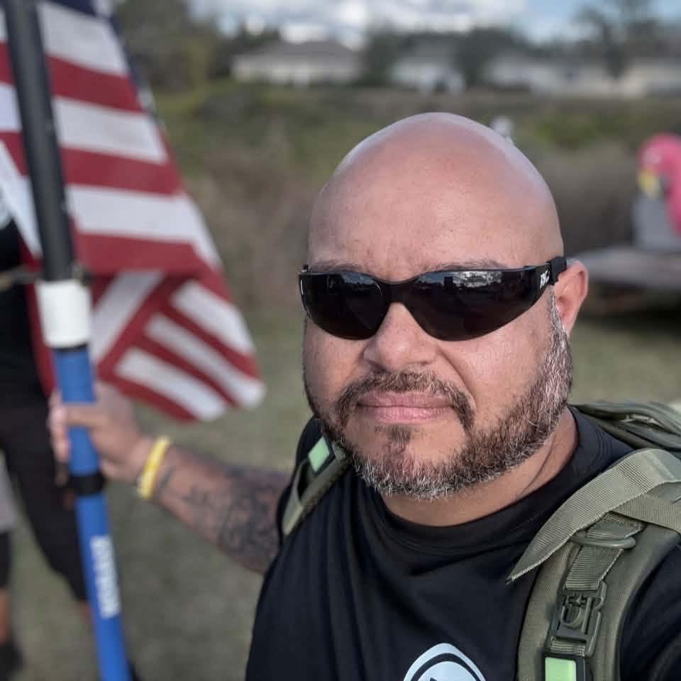Rick Cardona on a ruck event with American flags